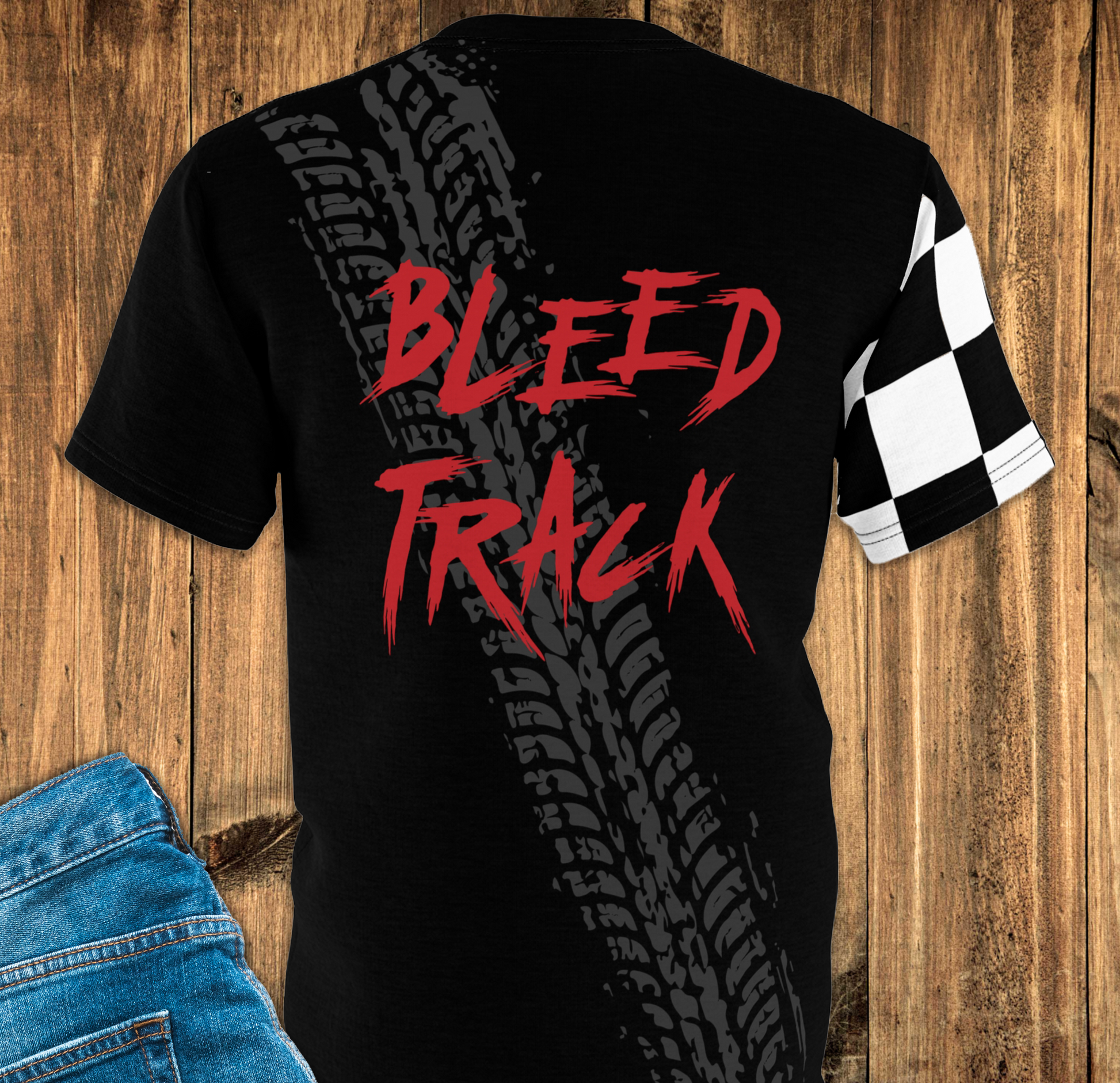 Black T-shirt with Tyre track print on the back place on wooden surface