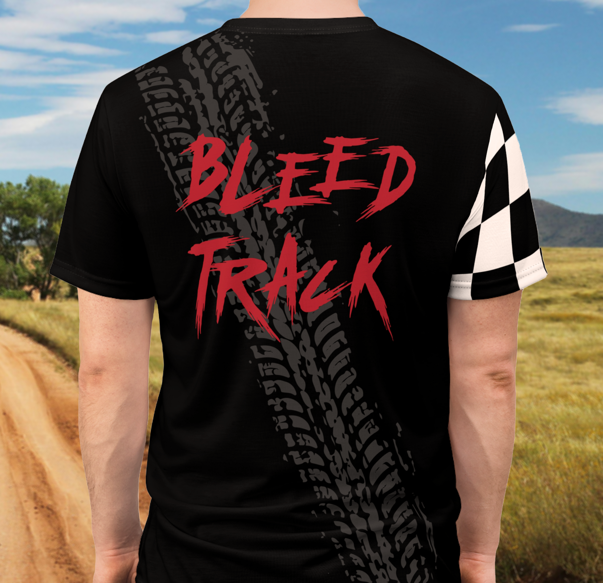 Biker wearing black t-shirt with Bleed Track written on the back outdoors